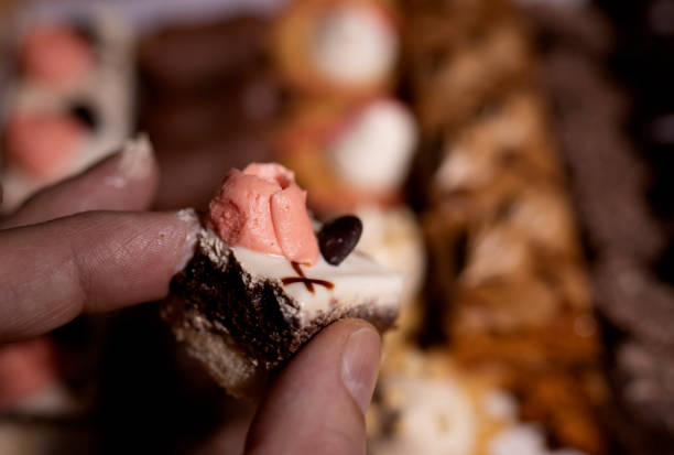 istock delicious cake in hand on a blurry background with sweets 1297406506
