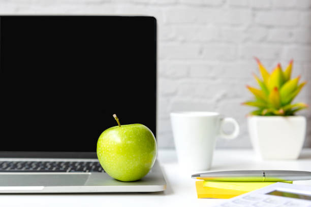 istock Healthy snack with working in office.  Close up Green apple with back coffee white cup for diet Health on white table working.  Healthy Lifestyle Concept 1297407012