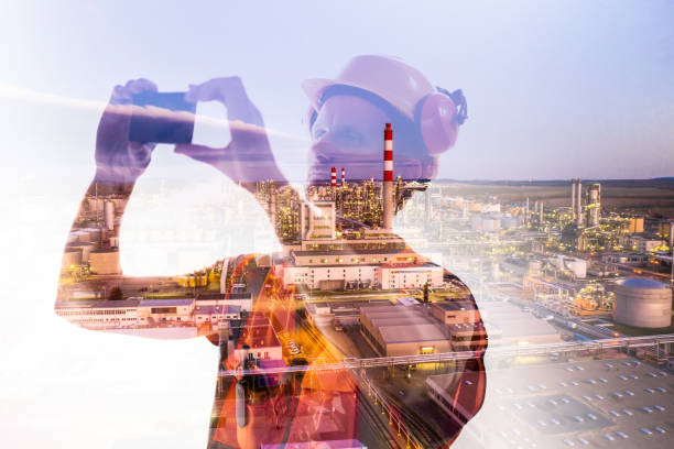 istock Construction engineer taking photo on mobile phone with crane exposure 1297407081
