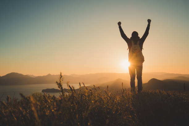 istock Young standing man with backpack. over sunset in nature 1297407106