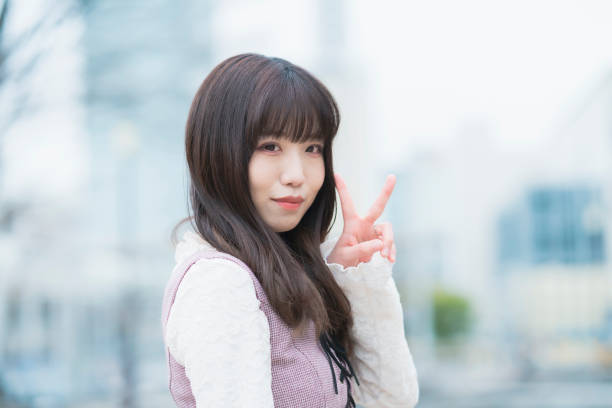 istock Young woman doing a peace sign 1297407320