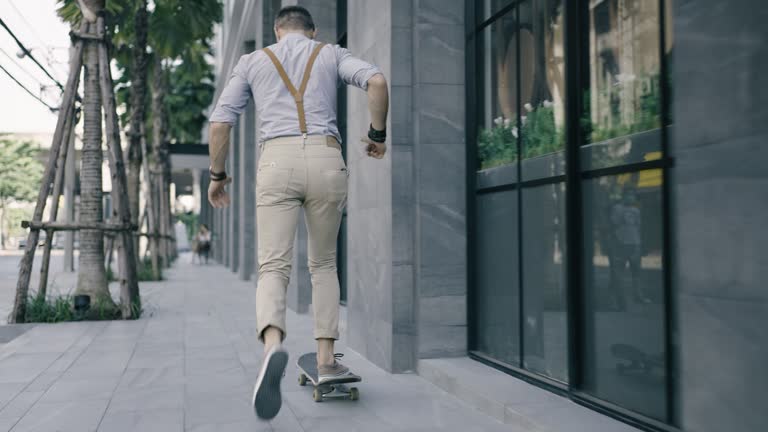 Man skateboarding on city street slow motion