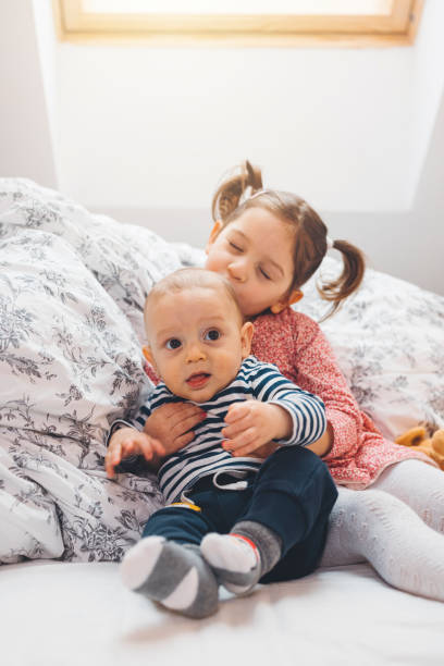 istock Siblings having playtime in their parents bed 1297408772