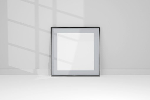 3d Mockup black frame photo on wall with shadows.