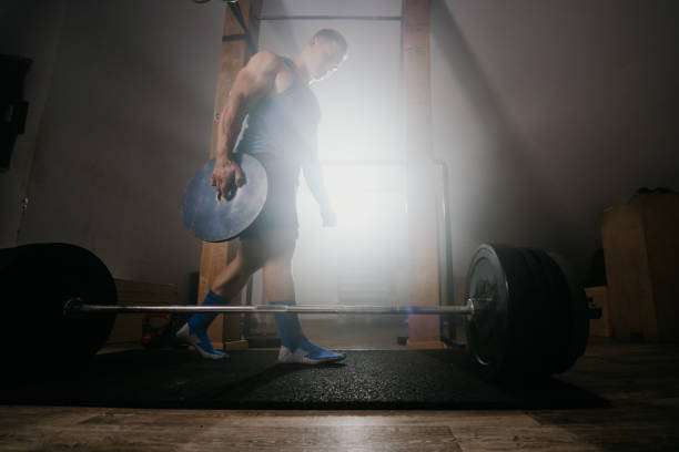 istock Muscular man carrying weight plate 1297409885