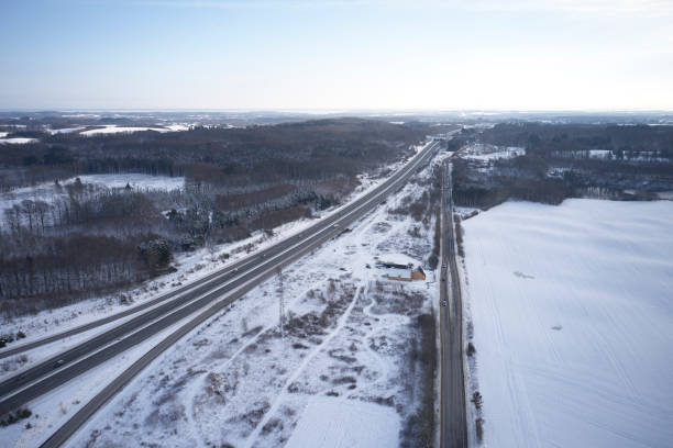 istock Winter landscape with snow and road 1297409943