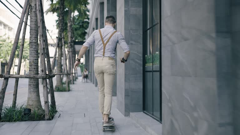 Man skateboarding towards the woman sitting at outdoor café