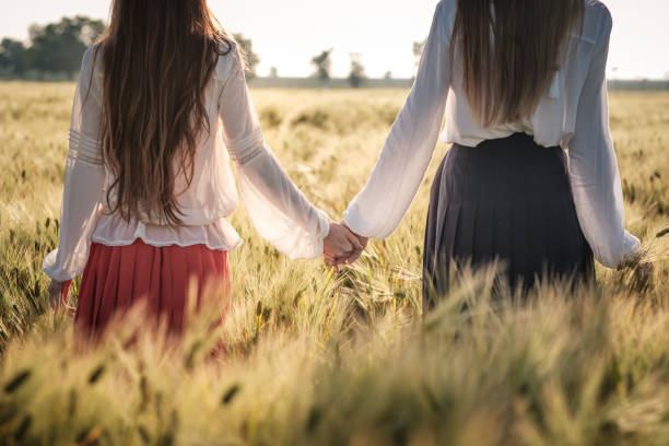 istock Red-haired girl in a wheat field at sunset. 1297411039