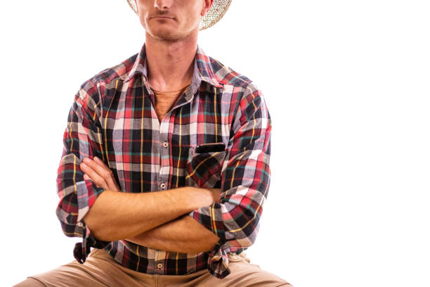 A studio portrait of a man wearing a white stetson hat