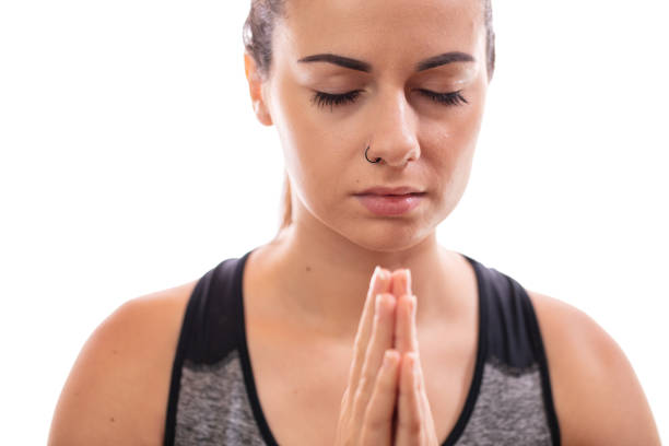 istock Young woman meditating with joined hands 1297412440