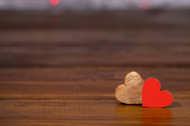 Two hearts on a wooden background with copy space. Valentine's day concept.