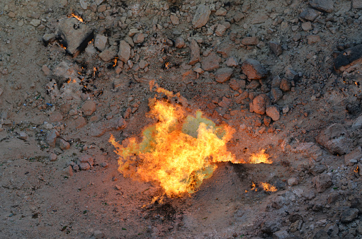 Karakum Desert north of Darvaza / Derweze, Dashoguz Province, Turkmenistan: fire at the center of Darvaza gas crater, also known as the Door to Hell or Gates of Hell, is a burning sinkhole in a natural gas field, the result of a collapsed cavern during a drilling operation. It it has been burning continuously since it was set alight by Soviet geologists in 1971. The crater has a diameter of approximately 70 meters and a depth of approximately 25 meters.