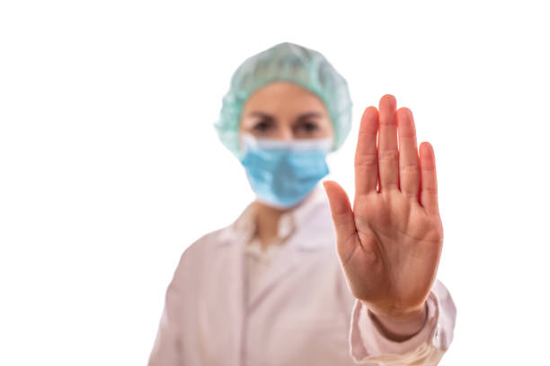 istock Female doctor showing stop sign with hand 1297412677