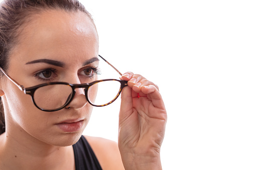 Close up face of woman holding her eyeglasses