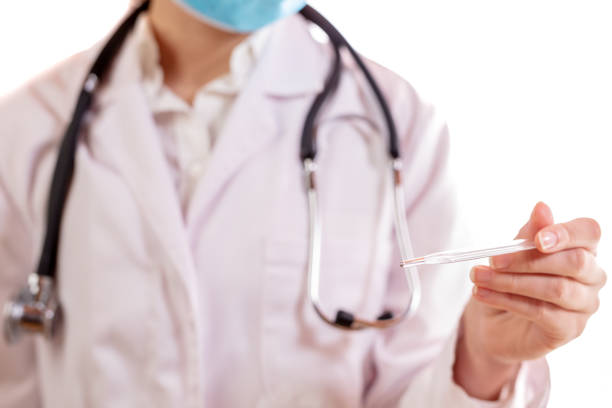 Close up of doctor holding thermometer in clinic