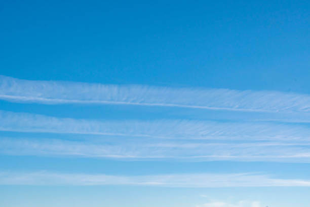 istock Background with blue sky and parallel airplane exhaust tracks. White chemtrails 1297413766