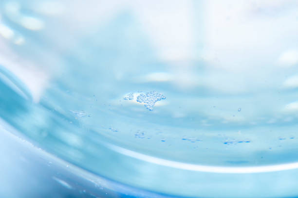 istock Abstract blue background with liquid and small bubbles on the surface. High magnification water. 1297413780