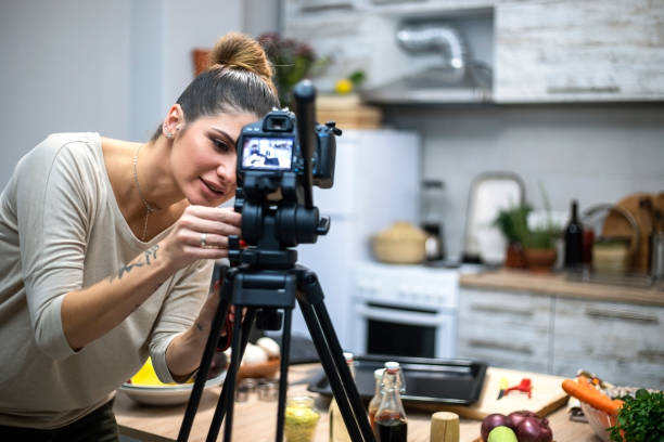 istock Young woman in her kitchen creating a cooking vlog 1297413865