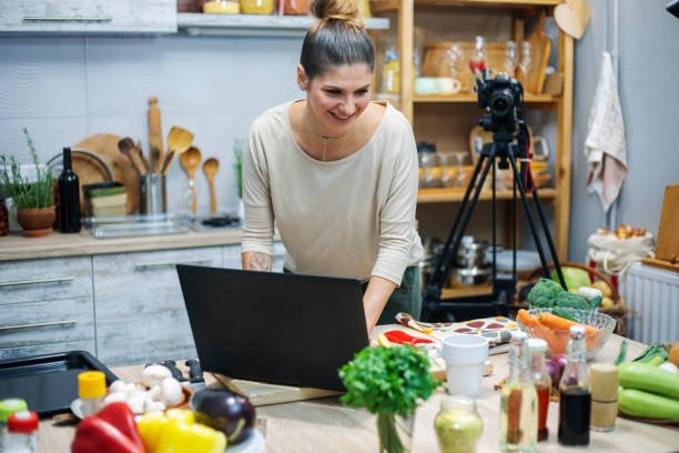 istock Young woman in her kitchen creating a cooking vlog 1297413869