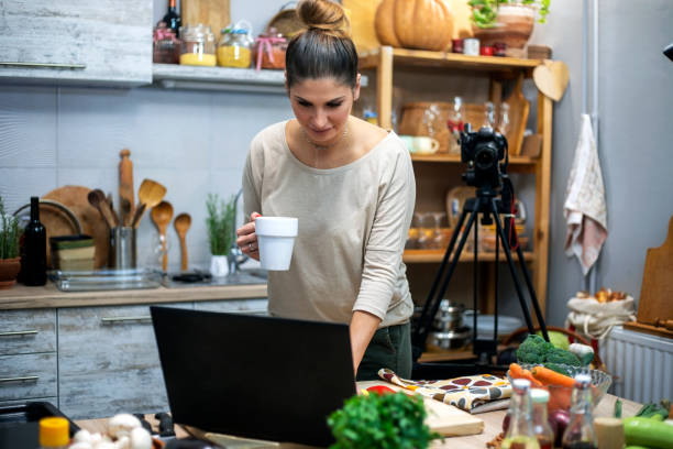 istock Young woman in her kitchen creating a cooking vlog 1297413882