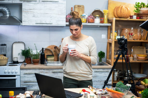 istock Young woman in her kitchen creating a cooking vlog 1297413885