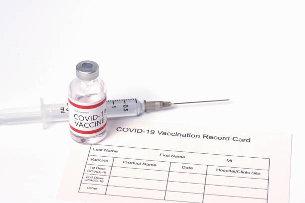 istock Coronavirus vaccine and immunization certificate on white background 1297414401