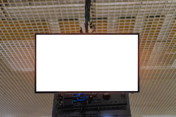 istock Mock up lcd smart TV or signboard for billboard banner display presentation at event convention exhibit trade show at booth  conference hall, white blank screen background 1297416199