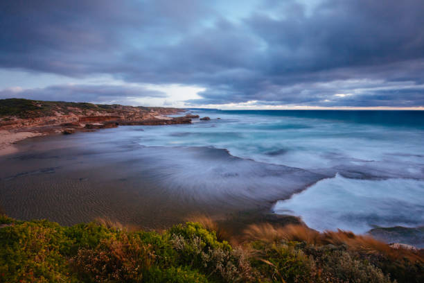 The idyllic Pearses Beach and headland around Pirates Bay Cove on a hot summer's evening near Blairgowrie, Victoria, Australia