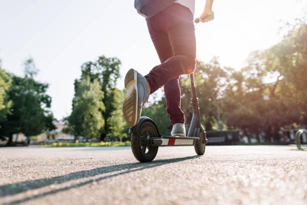 istock Student riding e-scooter through the city 1297417929