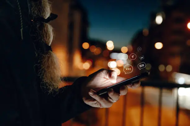 Close-up of bearded mature man using mobile phone