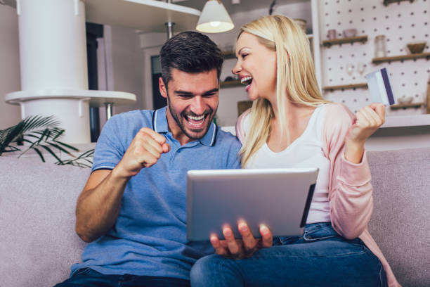 istock Young couple buying on internet using digital tablet and credit card. 1297418555