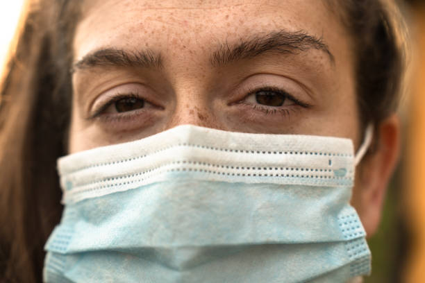 istock sad woman eyesight with face mask during the covid 1297418714
