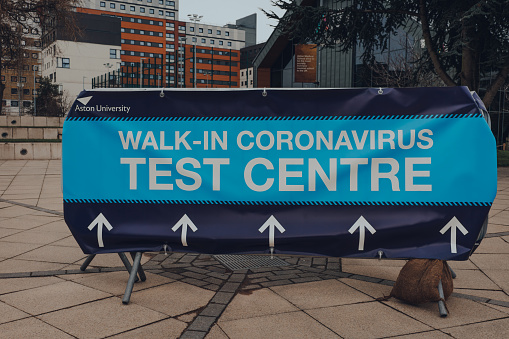 Birmingham, UK - January 17,2021: Directional sign to Walk-in Coronavirus Test Centre in Aston University Car Park, opened as part of UK-wide drive to continue to improve the accessibility of testing.