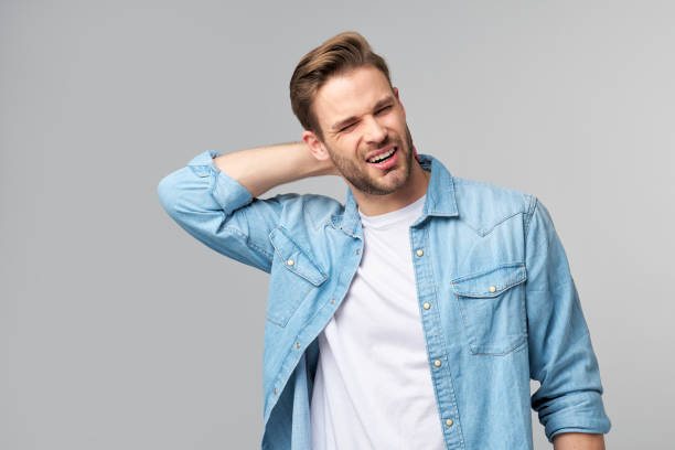 istock young handsome man with neck paint standing over grey background 1297420822