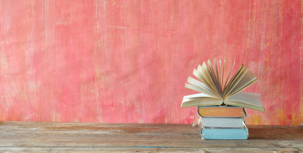 istock opened book and stack of book,reading,education,home office, back to school concept, free copy space 1297420993