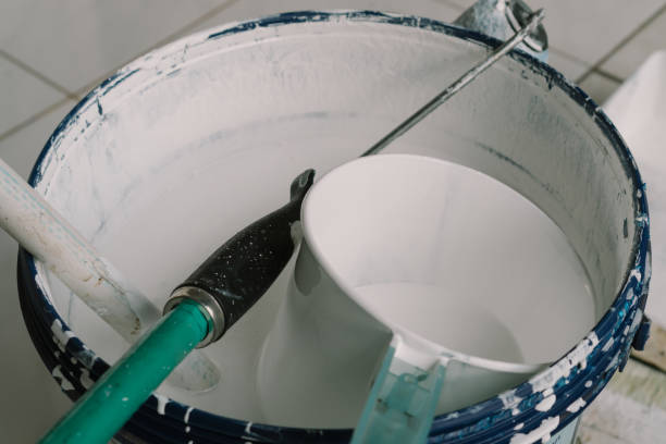 istock a bucket of white paint with a paint brush 1297421722