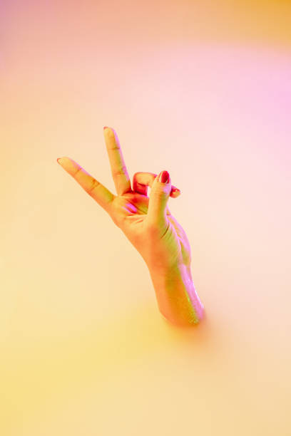 istock Close up female hand gesturing from the milk bath with soft glowing in neon light 1297421789