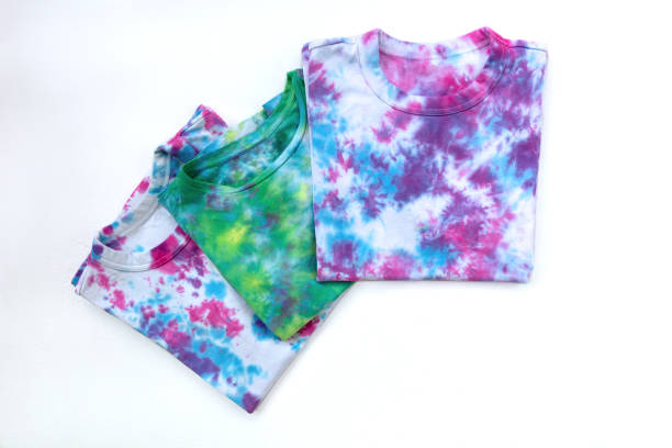 Three tie-dye T-shirt on white background. Top view.