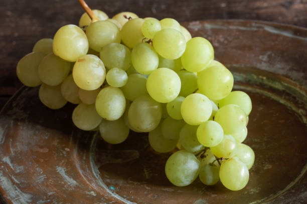istock Muscat Grapes on Antique Copper Platter 1297422551
