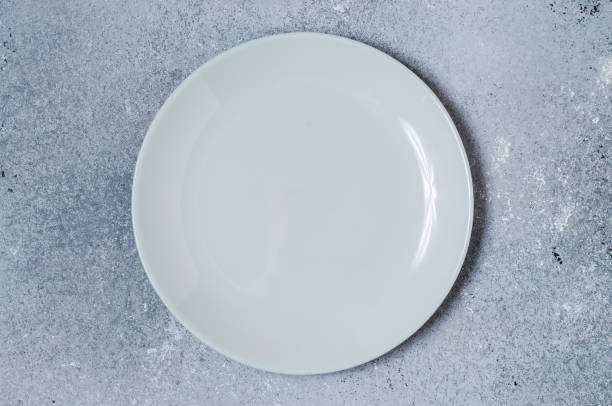 istock Blue concrete textured background for design with ceramic plate for food. Copy space 1297424568