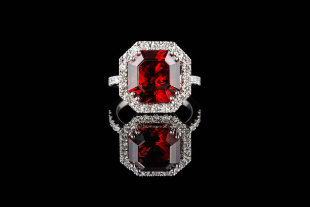 istock beautiful gold ring with gemstones garnet and diamonds on a black background 1297424840
