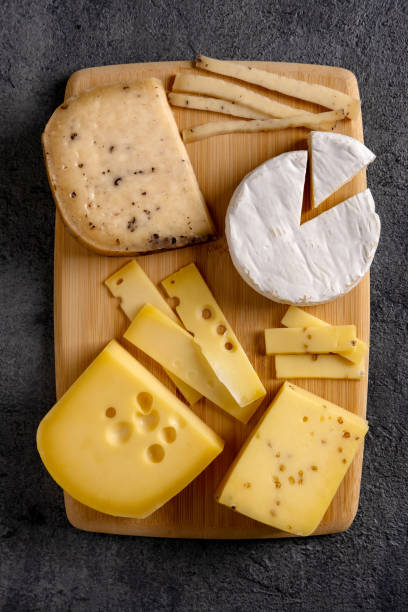 istock Cheese platter on wooden board. Cheese background. Closeup. 1297424920