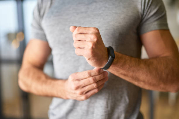 istock Athletic young man putting on smartwatch on his wrist 1297424996