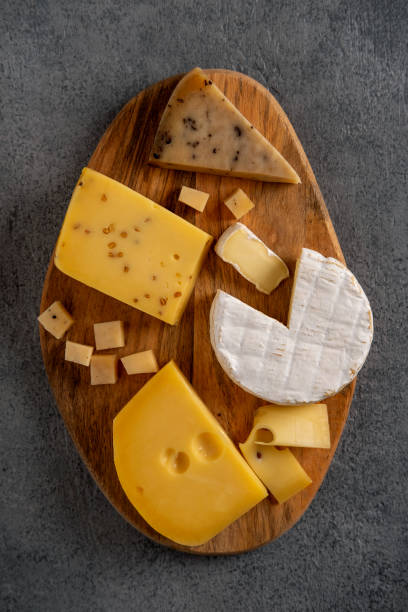 istock Cheese platter on wooden board. Cheese background. Closeup. 1297425758