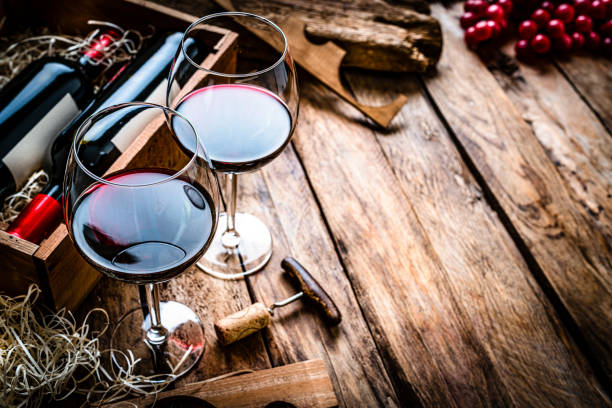istock Red wineglasses and wine bottles in a box. Copy space 1297426047