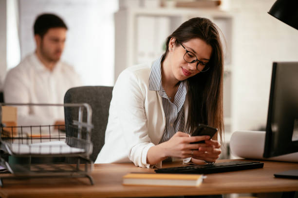 istock Businesswoman using the phone in the office. 1297426841