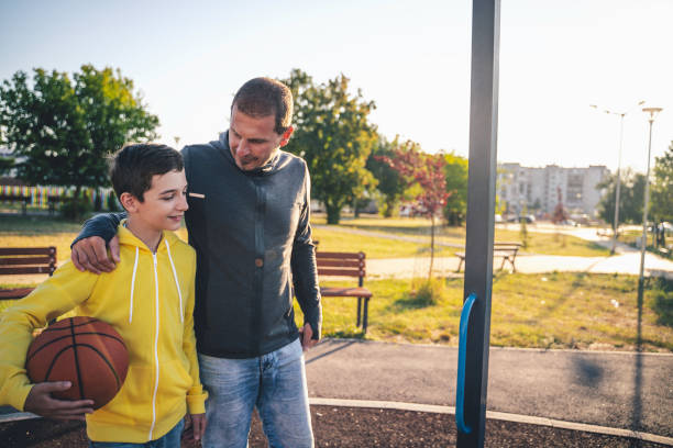 istock Morning Training. Father And Son Playing Basketball. Conversation between father and a son 1297426949