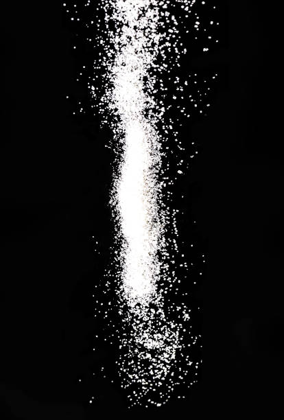 large big white sea salt falling on a black background. - sulfide imagens e fotografias de stock