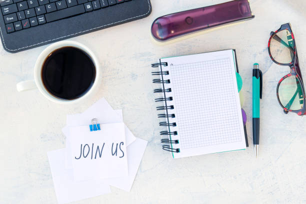 istock Join us. Job recruiting concept. Words Join us in a note on the working table 1297429083