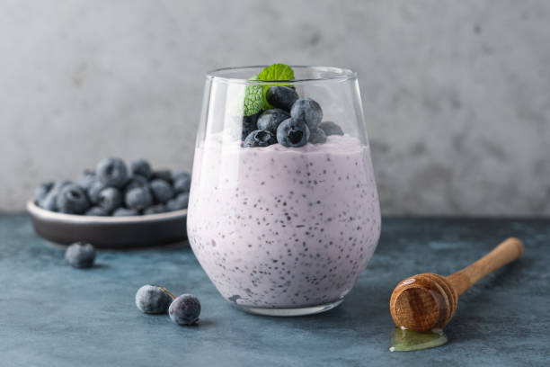 Blueberry chia pudding with fresh berries and honey stock photo